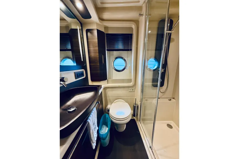 Slide: The Image of Luxurious bathroom in 2015 Azimut 50 yacht with modern fixtures and porthole windows. - 59