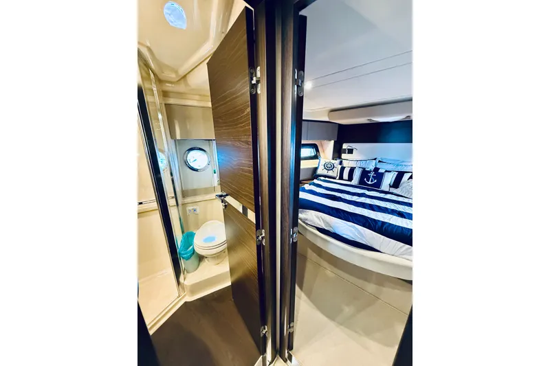 Slide: The Image of Luxurious 2015 Azimut 50 yacht interior with nautical-themed bedroom and compact bathroom. - 61