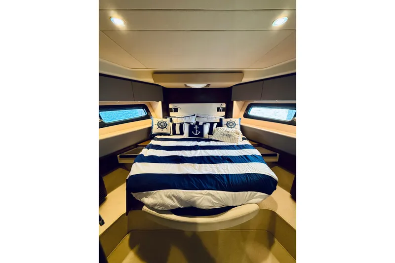 Slide: The Image of Luxurious bedroom interior of 2015 Azimut 50 yacht with nautical-themed bedding. - 62