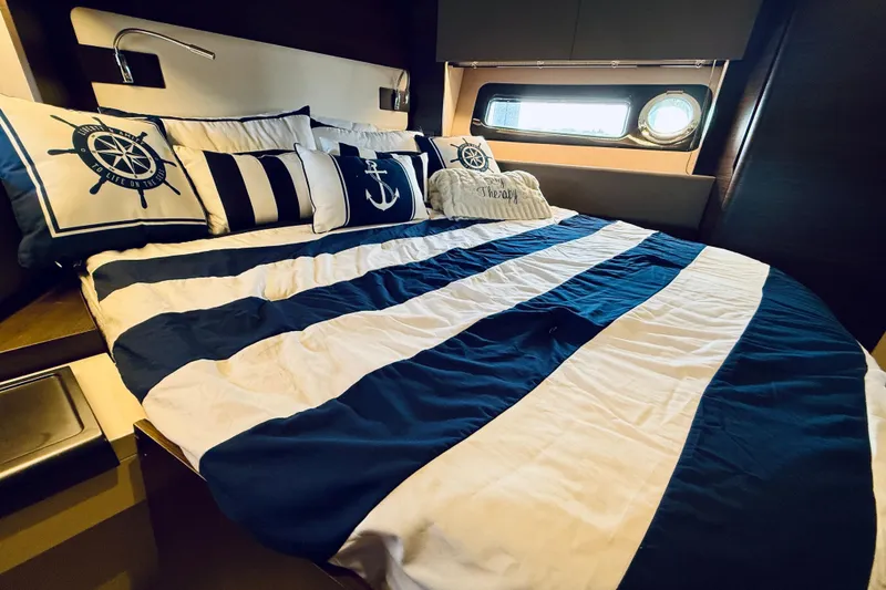 Slide: The Image of Luxurious nautical-themed bedroom in a 2015 Azimut 50 yacht with striped bedding. - 63