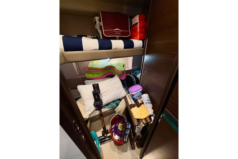 Slide: The Image of Storage area in a 2015 Azimut 50 yacht, filled with various items and equipment. - 66