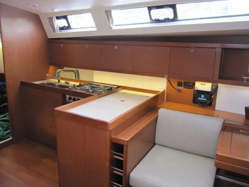 Slide: The Image of Interior of 2015 Beneteau Oceanis 45 yacht, featuring a modern kitchen and seating area. - 17
