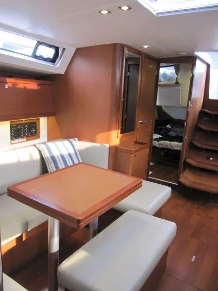 Slide: The Image of Interior of 2015 Beneteau Oceanis 45 yacht with wooden furnishings and cozy seating area. - 18