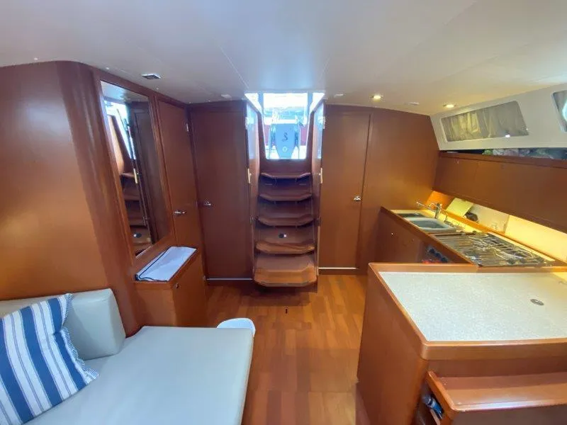 Slide: The Image of Interior of 2015 Beneteau Oceanis 45 yacht with modern kitchen and seating area. - 2