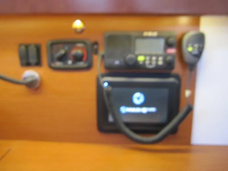 Slide: The Image of Control panel of a 2015 Beneteau Oceanis 45 sailboat, featuring navigation and communication equipment. - 22