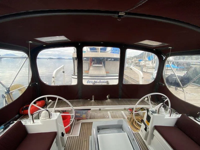 Slide: The Image of Interior view of 2015 Beneteau Oceanis 45 sailboat cockpit with dual steering wheels. - 23