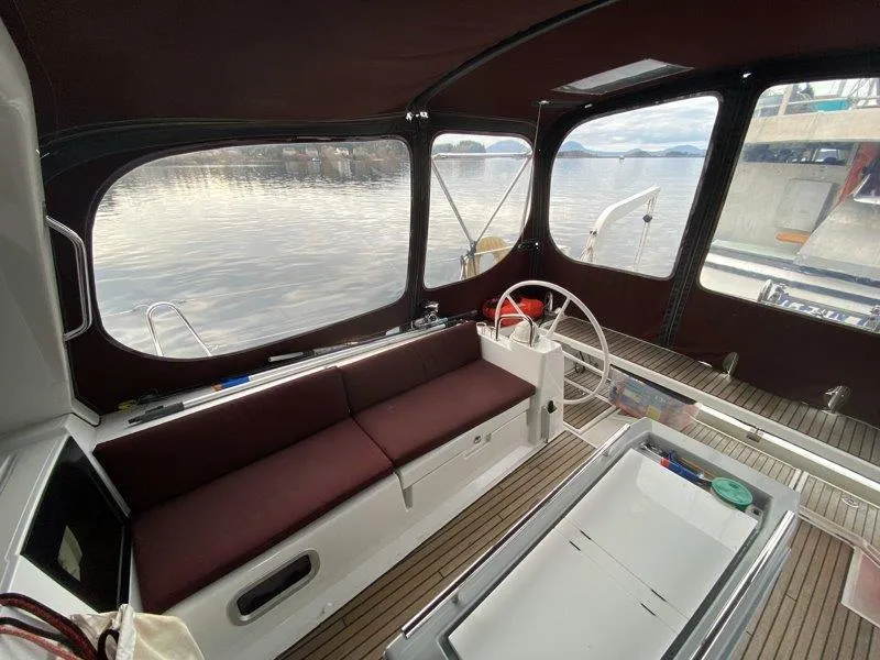 Slide: The Image of Beneteau Oceanis 45 cockpit, 2015 model, featuring spacious seating and scenic water views. - 24
