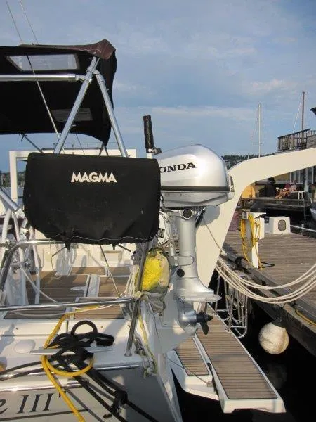 Slide: The Image of Beneteau Oceanis 45 sailboat with Honda outboard motor, docked at marina, 2015 model. - 32