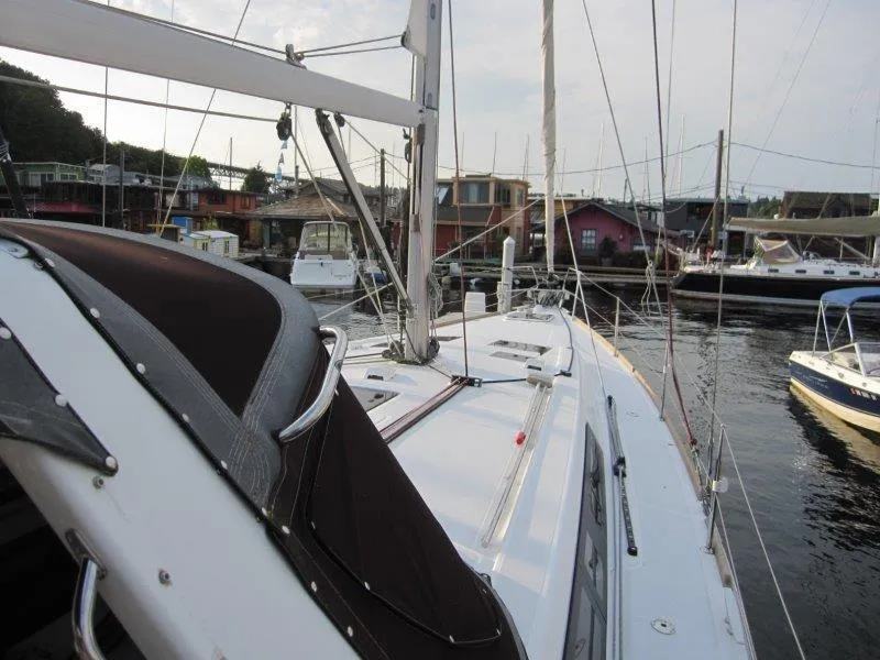 Slide: The Image of 2015 Beneteau Oceanis 45 sailboat docked in a marina, showcasing deck and rigging. - 37