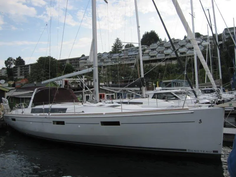 Slide: The Image of 2015 Beneteau Oceanis 45 sailboat docked in a marina, surrounded by other boats. - 46