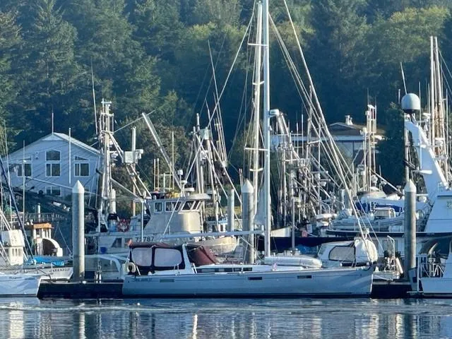 Slide: The Image of Beneteau Oceanis 45 sailboat docked in a marina, surrounded by other boats, 2015 model. - 52