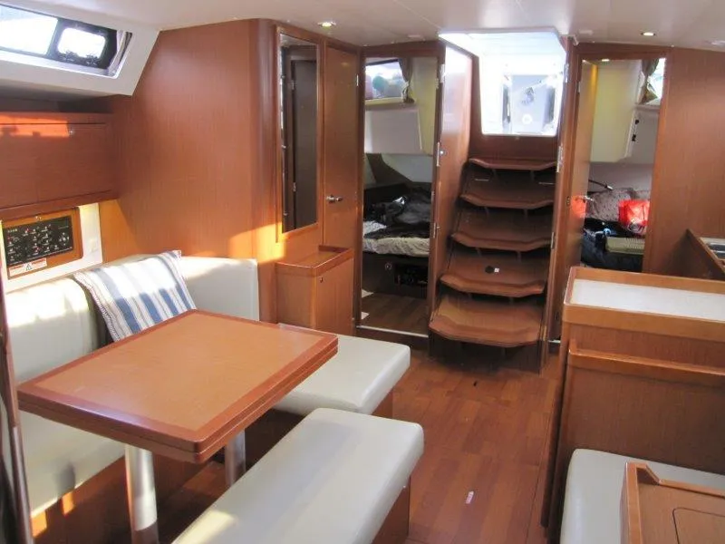 Slide: The Image of Interior of 2015 Beneteau Oceanis 45 yacht with wooden finish and seating area. - 9