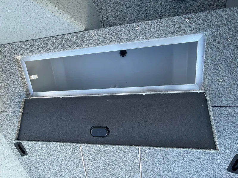 Slide: The Image of 2025 Lund 1400 Fury SS boat storage compartment, open and empty. - 12