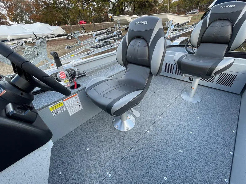 Slide: The Image of 2025 Lund 1400 Fury SS boat interior with two swivel seats. - 13