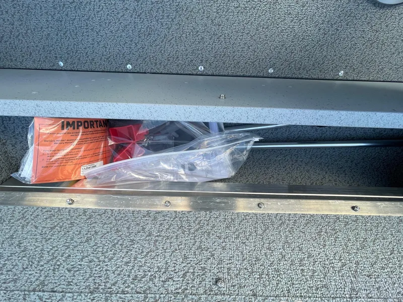 Slide: The Image of Storage compartment in 2025 Lund 1400 Fury SS boat with safety equipment. - 14