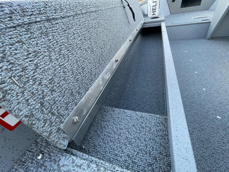 Slide: The Image of 2025 Lund 1400 Fury SS boat storage compartment, open and empty. - 16
