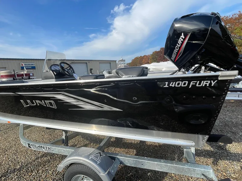Slide: The Image of 2025 Lund 1400 Fury SS boat on trailer, featuring a Mercury outboard motor. - 3