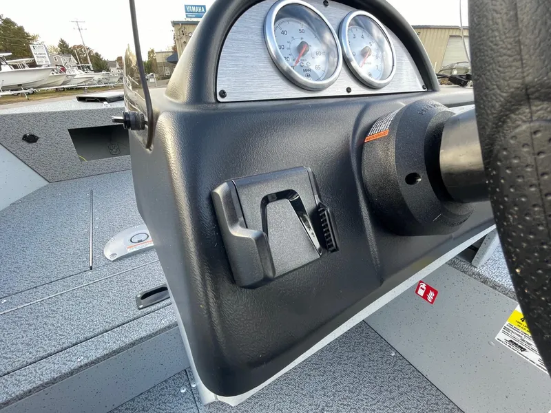 Slide: The Image of 2025 Lund 1400 Fury SS boat dashboard with gauges and steering wheel. - 4