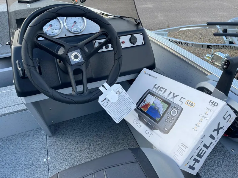 Slide: The Image of 2025 Lund 1400 Fury SS boat dashboard with Helix 5 GPS system. - 5