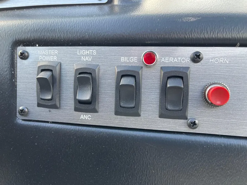 Slide: The Image of Control panel of 2025 Lund 1400 Fury SS boat with switches and buttons. - 8