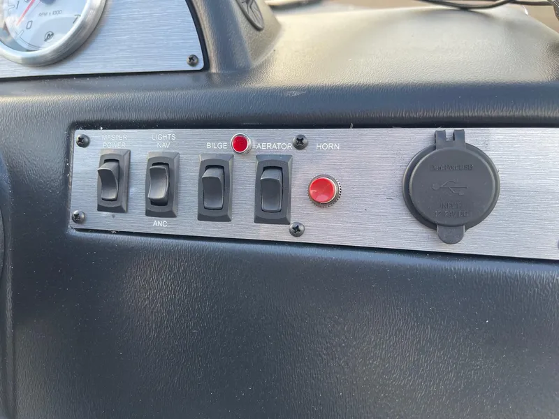 Slide: The Image of Control panel of 2025 Lund 1400 Fury SS boat with switches and outlets. - 9