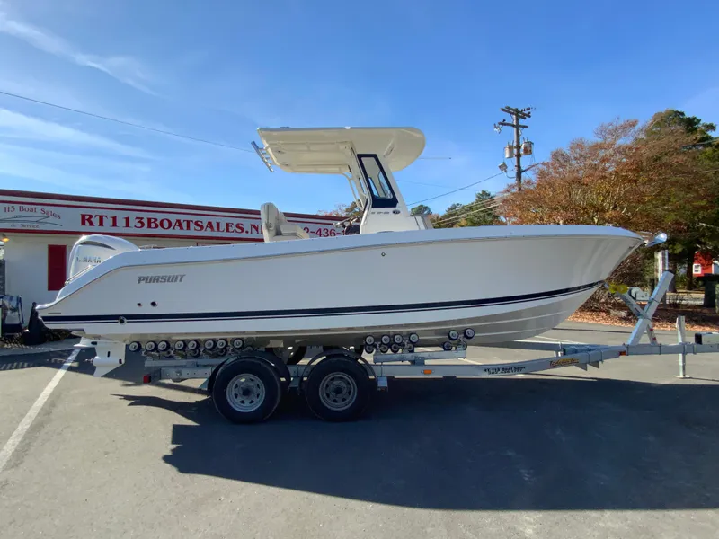 The Image of 2025 Pursuit S 248 Sport boat on trailer at dealership. - 0