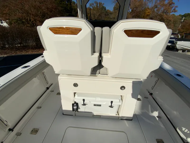 Slide: The Image of 2025 Pursuit S 248 Sport boat interior with dual seats and storage compartment. - 12