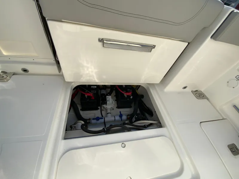 Slide: The Image of 2025 Pursuit S 248 Sport boat battery compartment with storage drawer. - 16