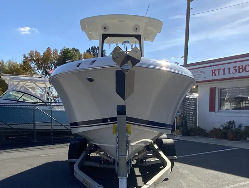 Slide: The Image of 2025 Pursuit S 248 Sport boat on trailer, outdoor display. - 2