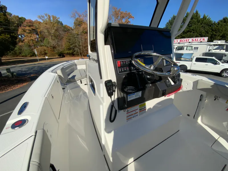 Slide: The Image of 2025 Pursuit S 248 Sport boat interior with steering console and controls. - 22