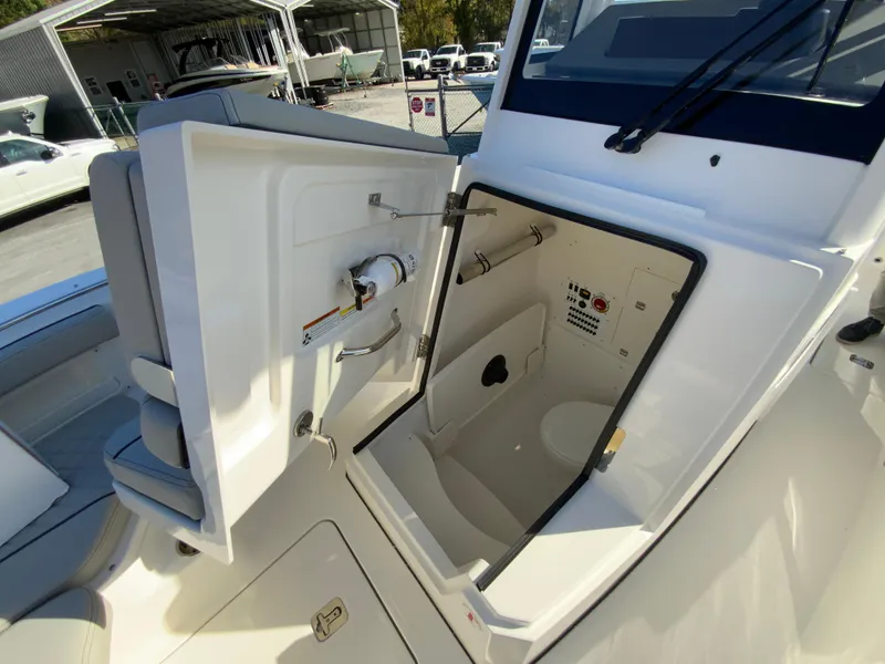 Slide: The Image of 2025 Pursuit S 248 Sport boat interior with open storage compartment. - 29