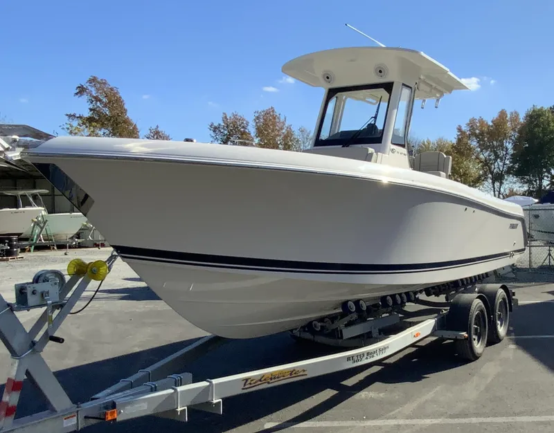 Slide: The Image of 2025 Pursuit S 248 Sport boat on trailer, parked outdoors. - 3