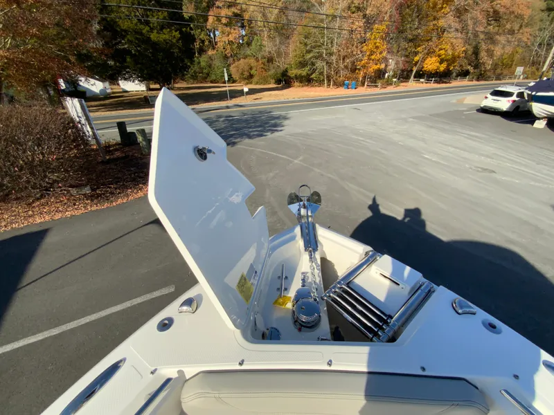 Slide: The Image of 2025 Pursuit S 248 Sport boat anchor compartment in a parking lot. - 40