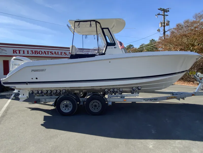 Slide: The Image of 2025 Pursuit S 248 Sport boat on trailer at dealership. - 45