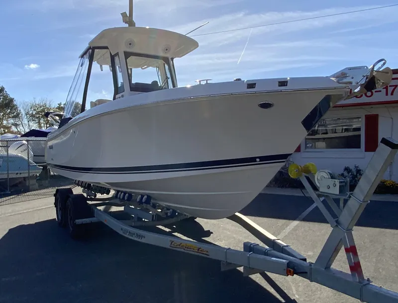 Slide: The Image of 2025 Pursuit S 248 Sport boat on trailer under clear sky. - 46