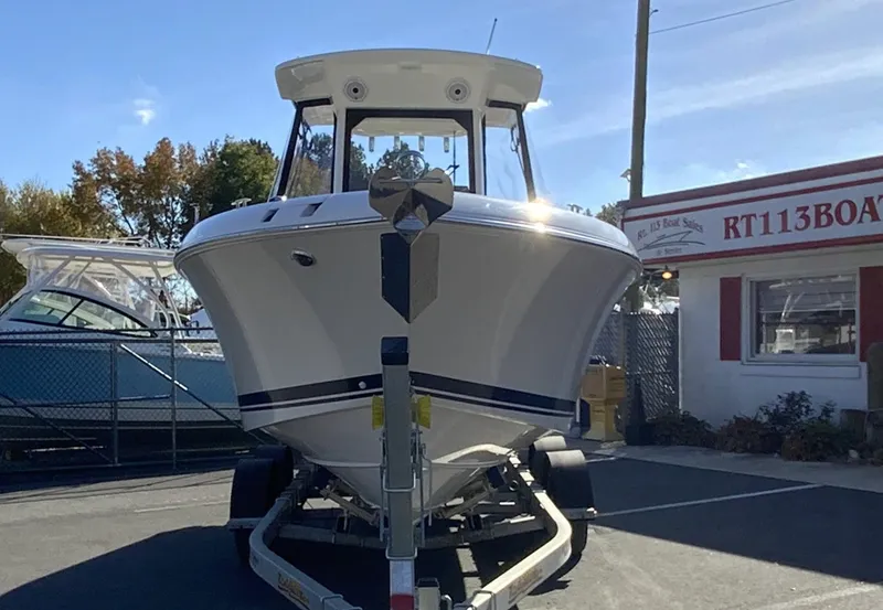 Slide: The Image of 2025 Pursuit S 248 Sport boat on trailer at dealership. - 47