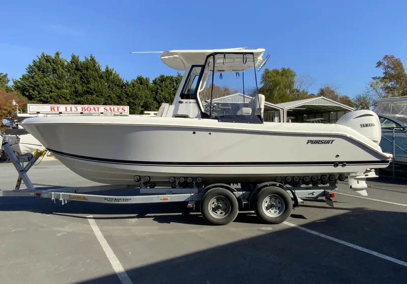 Slide: The Image of 2025 Pursuit S 248 Sport boat on trailer at dealership. - 49