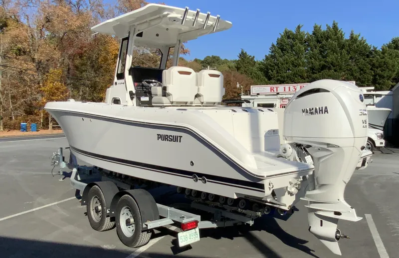 Slide: The Image of 2025 Pursuit S 248 Sport boat on trailer with Yamaha engine, parked outdoors. - 5