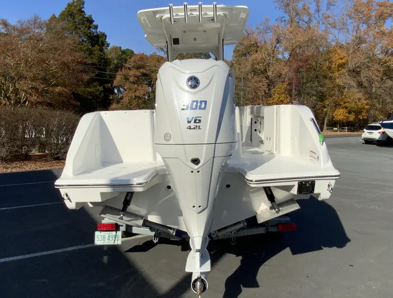 Slide: The Image of 2025 Pursuit S 248 Sport boat with Yamaha V6 engine, parked outdoors. - 6