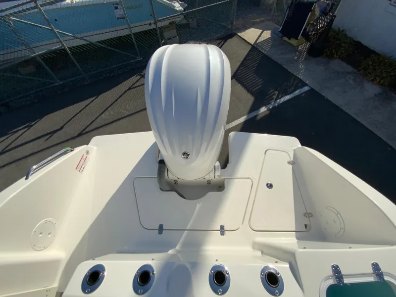 Slide: The Image of 2025 Pursuit S 248 Sport boat with powerful outboard motor, docked in marina. - 8