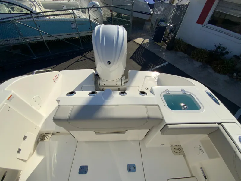 Slide: The Image of 2025 Pursuit S 248 Sport boat deck with motor and seating area. - 9