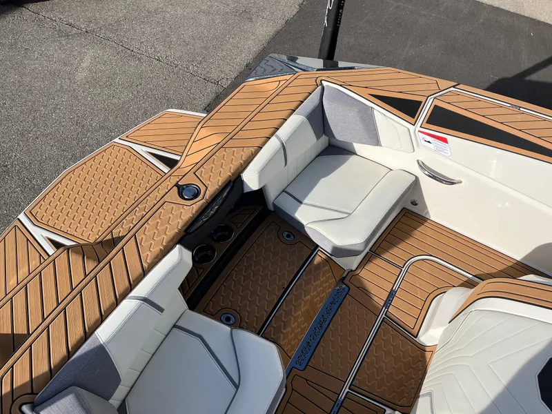 Slide: The Image of 2024 Nautique Ski Nautique boat interior with stylish seating and teak flooring. - 13