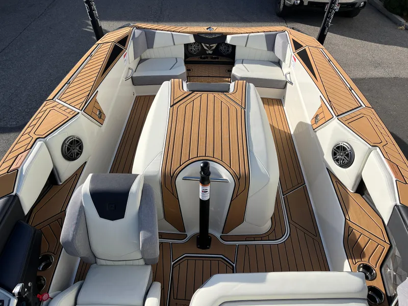 Slide: The Image of 2024 Nautique Ski Nautique boat interior with teak flooring and white seating. - 18