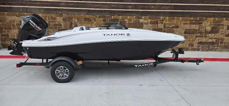 Slide: The Image of 2025 Tahoe T16 boat on trailer, parked outdoors. - 0