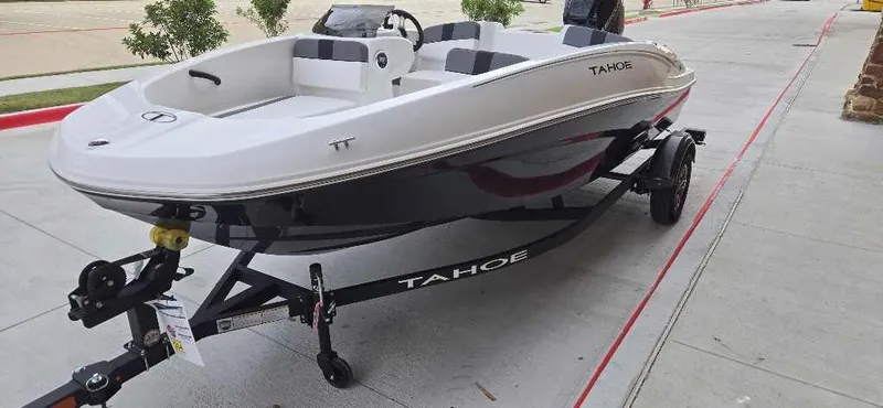 Slide: The Image of 2025 Tahoe T16 boat on trailer, parked on concrete pavement. - 3