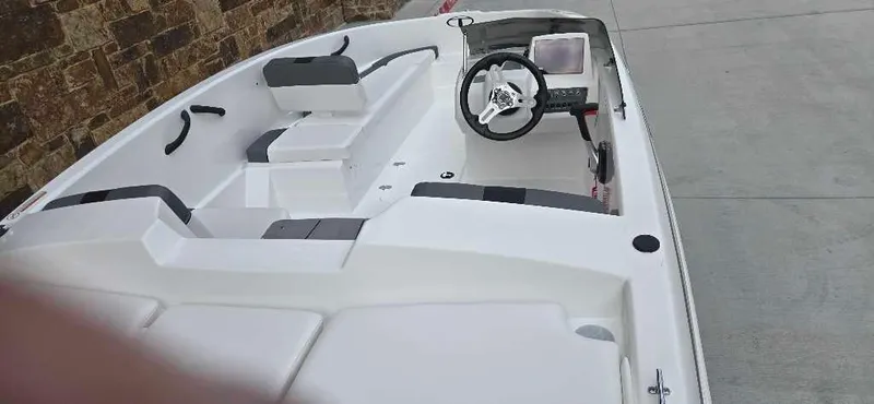 Slide: The Image of 2025 Tahoe T16 boat interior with steering wheel and seating. - 6
