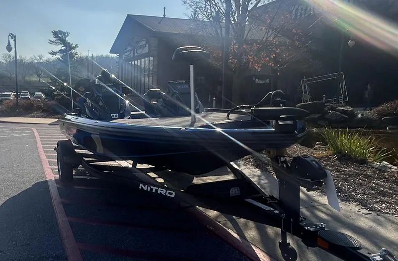 Slide: The Image of 2025 Nitro Z18 boat on trailer in sunny outdoor setting. - 2