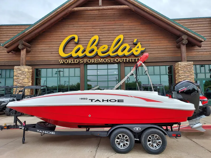 The Image of Red 2025 Tahoe 1950 boat on trailer outside Cabela's store. - 0