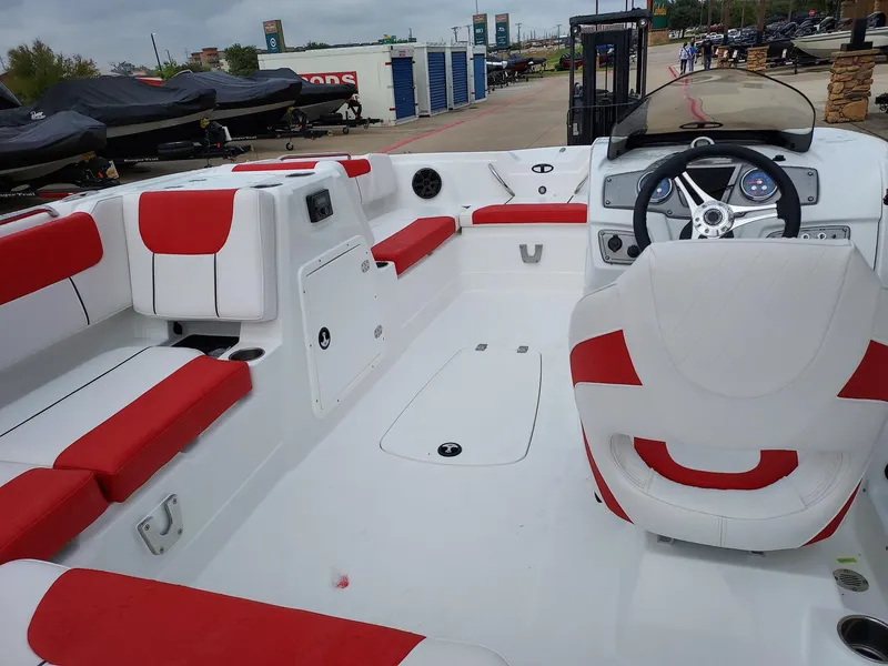 Slide: The Image of Interior of a 2025 Tahoe 1950 boat with red and white seating. - 1