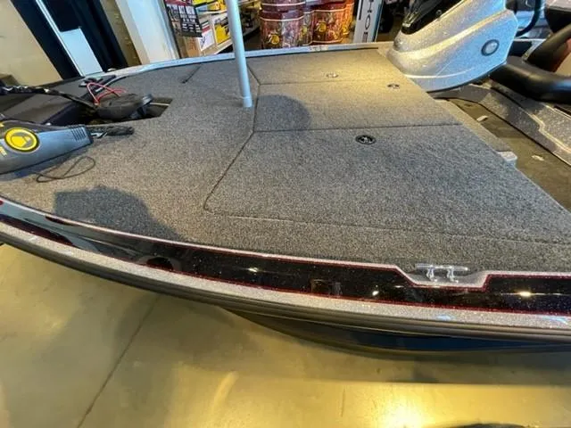 Slide: The Image of 2025 Nitro Z17 boat deck with carpeted surface and storage compartments. - 7